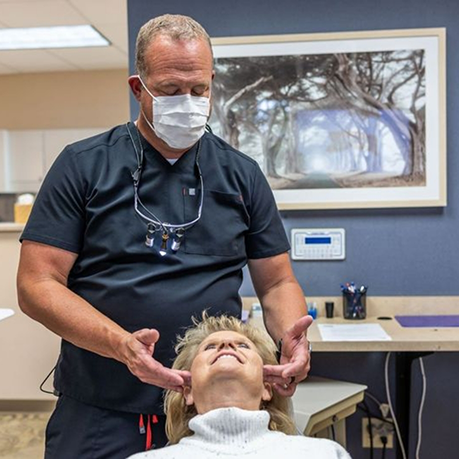 Sleep dentist performing an exam on a patient