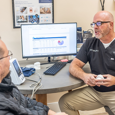 Jack talking to a patient at a desk