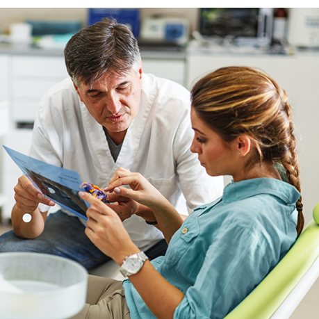 Sleep dentist showing an oral appliance to a patient