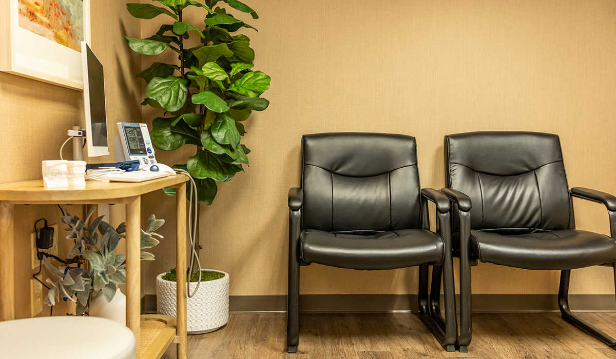 Two black leather chairs in waiting area