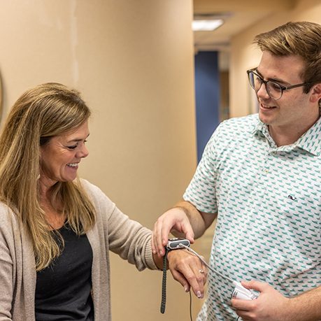 Sleep dentist placing a sleep testing device on a patients wrist