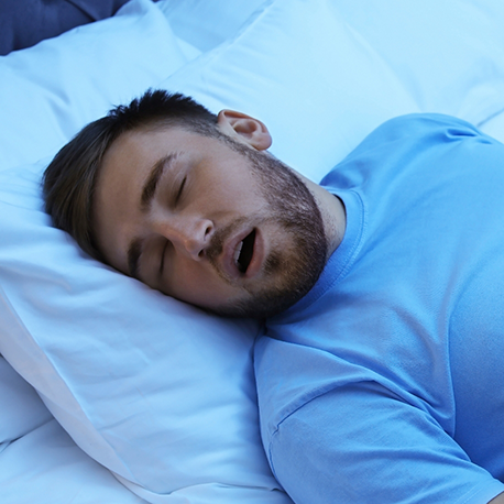 Man sleeping on his back with his mouth open